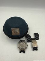 Watch face, detached bracelet pieces, Guess case