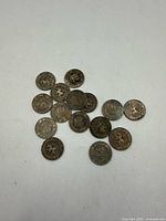 All fifteen Belgium 10 centimes coins spread on flat surface