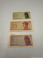 Three Indonesian sen banknotes showing obverse sides and denominations 10, 25, 5