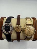 Front view of all three Bulova wristwatches on display stand