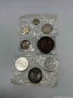front view showing all nine coins sealed in plastic
