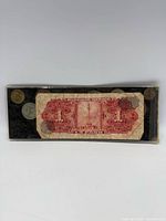 Front view of display showing 1 Peso banknote and surrounding coins