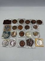 Overhead view of entire group of medals and tokens in flips