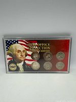 Front view of plastic case showing six Washington quarters and insert graphics