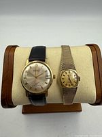 Both Longines watches on display stand showing fronts