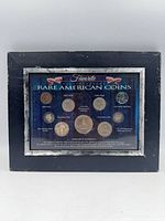 Framed display of nine coins, overall view
