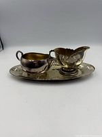 Front view of creamer and sugar bowl on tray