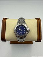 Front view of Timex watch on stand showing dial, bezel and bracelet