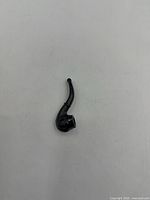 miniature black plastic pipe toy, curved stem, overall view