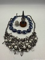 Full lot view showing both necklaces and both rings