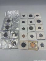 Coins laid out in holders showing dates and sleeves, full lot visible