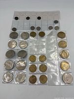 Sheets of assorted coins in flips