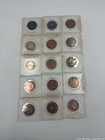 Overall view of 15 Canadian one-cent coins in individual plastic cases