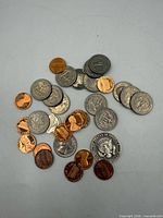 Overhead view of mixed U.S. coins showing denominations and circulated condition