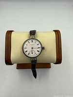 Front view of Elgin trench wristwatch on stand