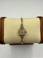 Front view of Lorie wristwatch on display pillow