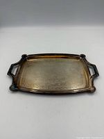 top view of rectangular silver-plated tray showing handles and patina