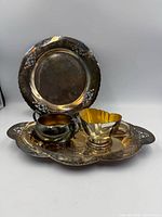 entire set showing sugar bowl, creamer, oval tray, round tray