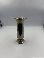 Front view of silver-plated bud vase showing body and base