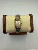 Front view of Wittnauer watch on stand showing case, dial, and band