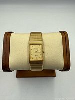 Front view of Wittnauer gold-tone rectangular quartz watch on display pillow