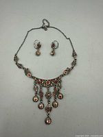 Full view of necklace and earrings layout