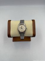 Front view of Omega Seamaster watch on display stand showing dial and bracelet