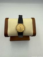 Front view of Omega wristwatch on display stand