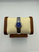 Front view of Tag Heuer ladies stainless steel wristwatch on display stand showing blue dial