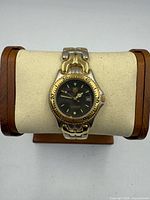 Front view of Tag Heuer two-tone watch on display pillow