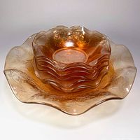 Stacked view showing one large bowl holding seven small matching bowls