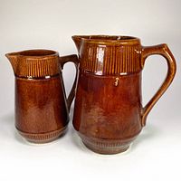 Front view of both brown stoneware pitchers