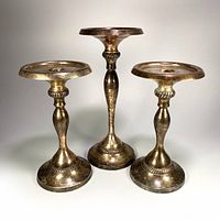Front view of all three silver plated candle holders
