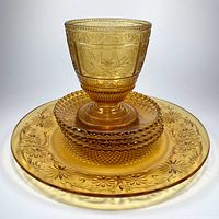Group shot of spooner stacked on four side plates atop large cake plate