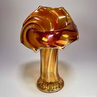 Front view of marigold carnival glass vase showing jack-in-the-pulpit rim and paneled body