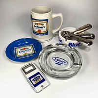Group shot of stein, three ashtrays and four openers