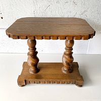 Full view of oak plant stand showing top, supports, and base