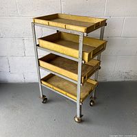 Front view of metal cart with four yellow trays