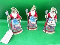 Three identical Australian Santa figurines front view