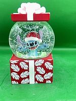 Front view of snow globe showing Stitch figure and base