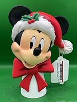Front view of Mickey Mouse resin tree topper showing face, hat and bow