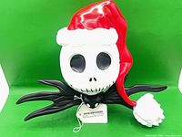 Front view of Jack Skellington tree topper showing full figure, tag visible