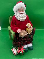 Front view of Santa figurine with pets and gifts