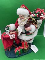 Full view of Cat Burgler Santa figurine with table, cat, gifts
