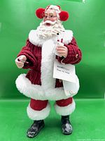 Front view of Santa figurine showing full attire, accessories, and hang tag