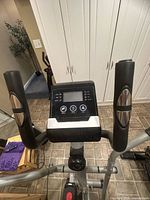 Console and handlebars of elliptical showing controls and condition