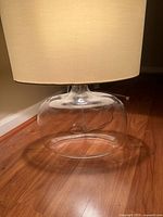 Side view of lamp showing clear glass base and shade
