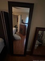 Front view of full-length mirror leaning against wall