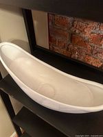 Angled view showing interior and curved rim of white ceramic bowl