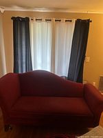 Front view of red chaise lounge against window